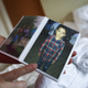 An immigrant who identified herself only as Vioney, recently released after spending six months in an ICE detention facility, displays a photo of her son in her hotel room before flying to be reunited with family members on September 2, 2018 in Los Angeles, California.